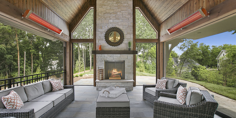 A hanging gas patio heater in an outdoor lounge space